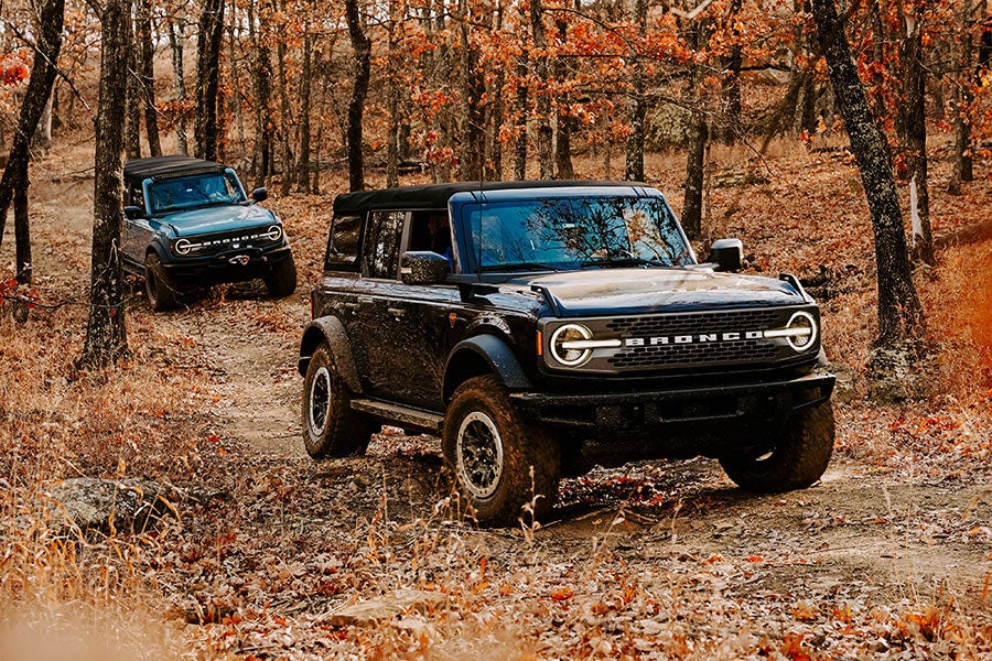 A front view of a black Ford Bronco off-roading.