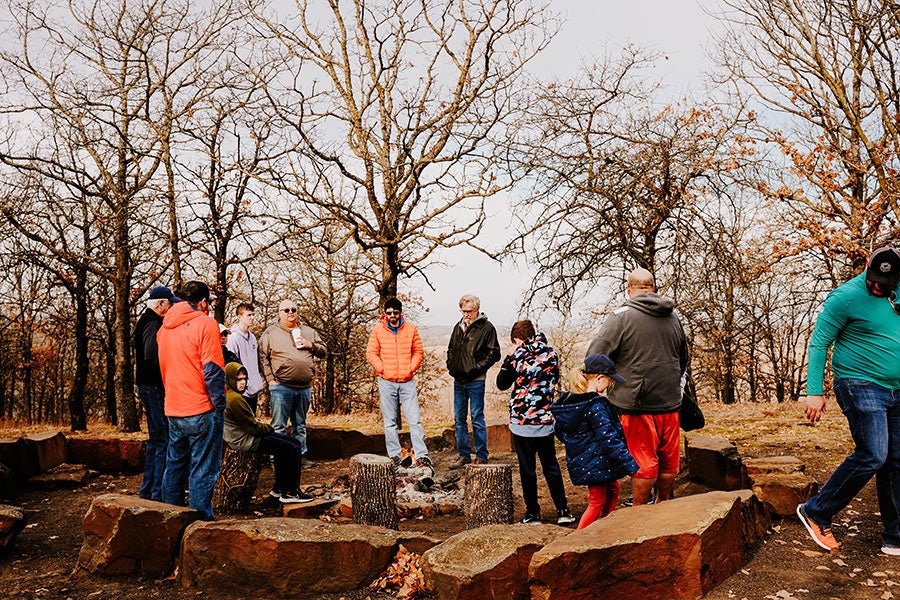 A group of people gathered around a Ford Bronco.