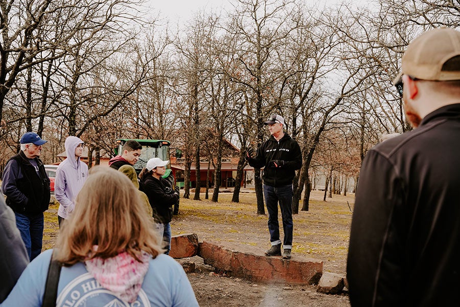 A group of people standing and talking outside.