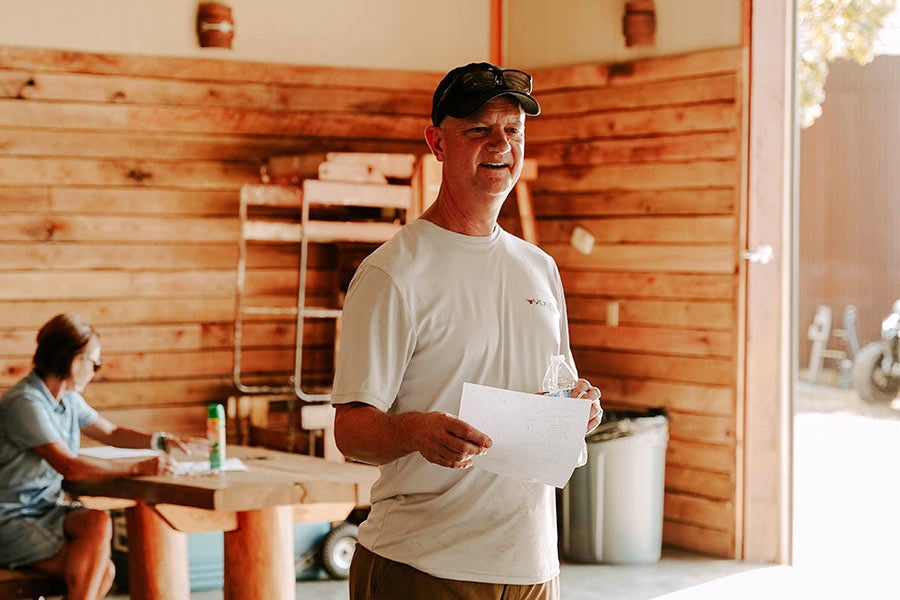 A man and a woman sitting at a table in a rustic building.