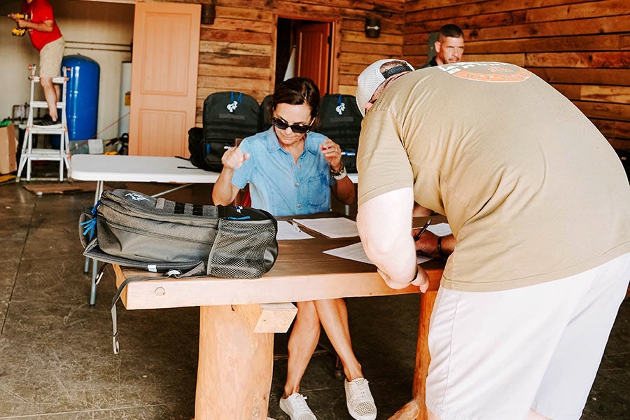 A man and a woman sitting at a table in a rustic building.
