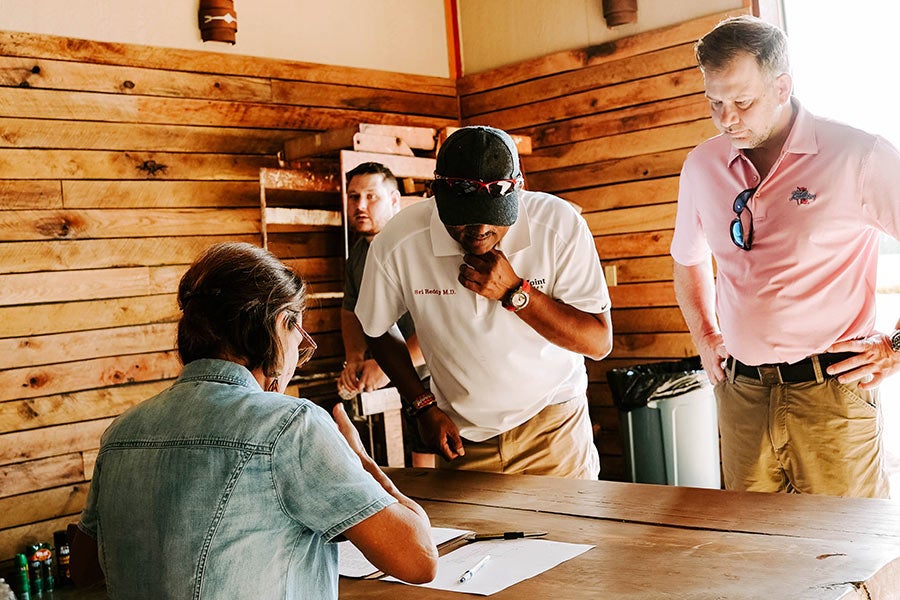A man and a woman sitting at a table in a rustic building.