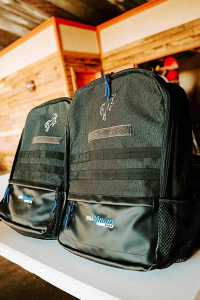 A man and a woman sitting at a table in a rustic building.