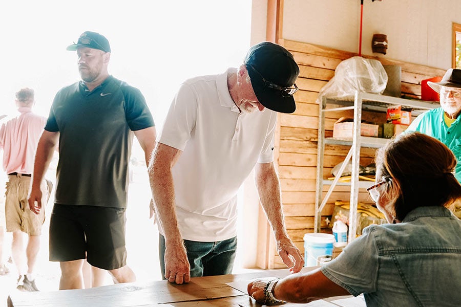 A man and a woman sitting at a table in a rustic building.
