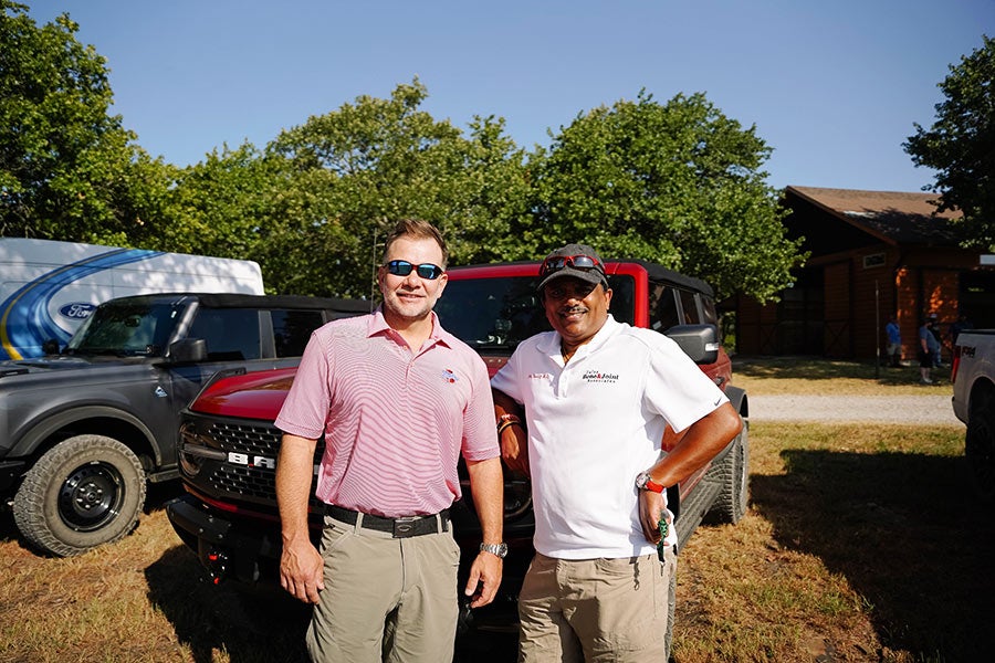 A man and a woman sitting at a table in a rustic building.