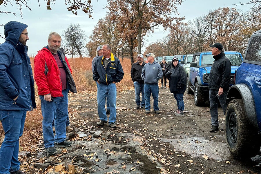 A group of people standing outside on a cloudy day