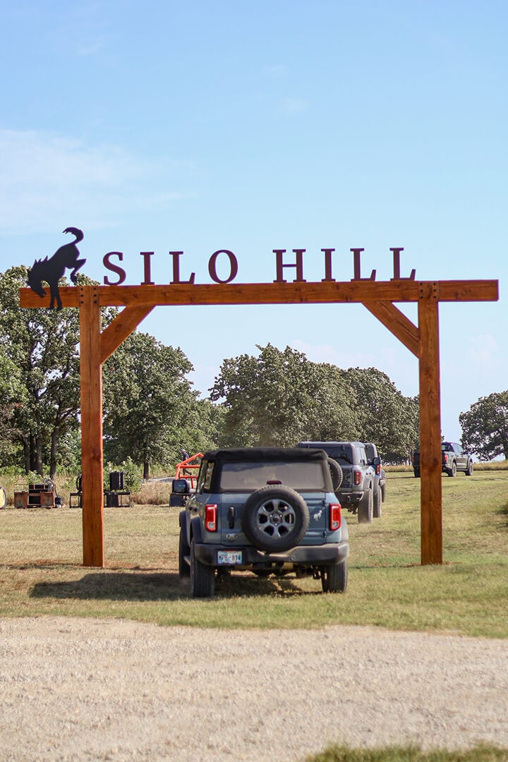 A line of Ford Broncos parked under an archway