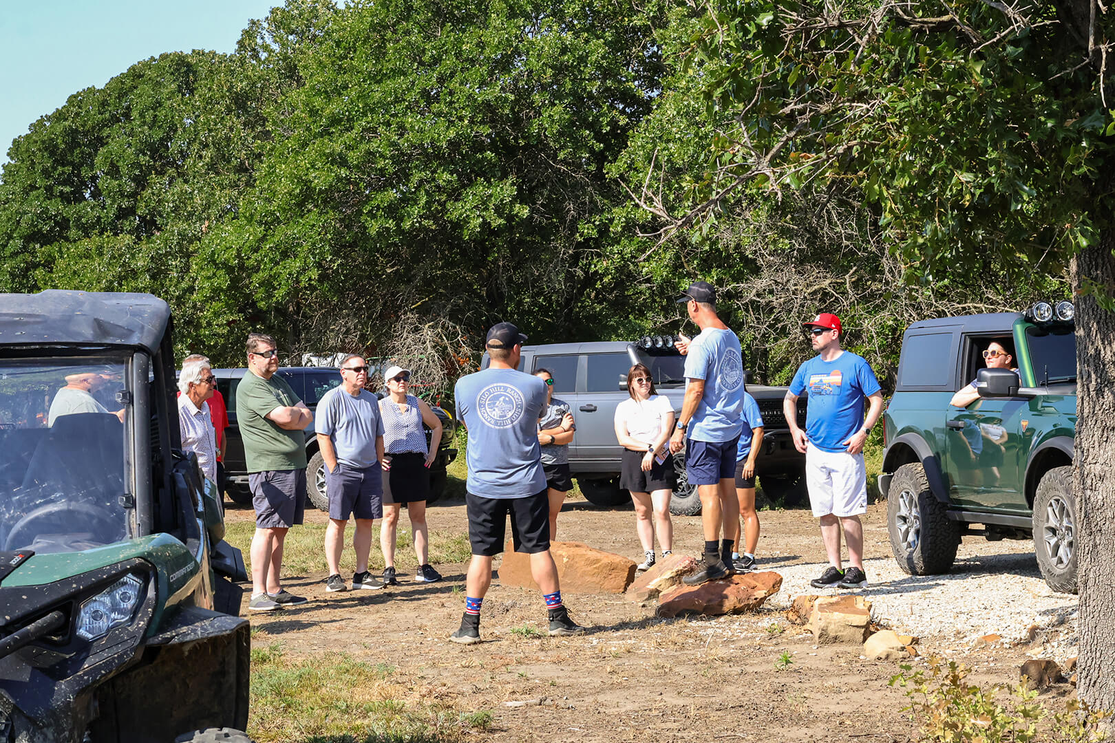 A group of people posing for a photo with a Ford Bronco