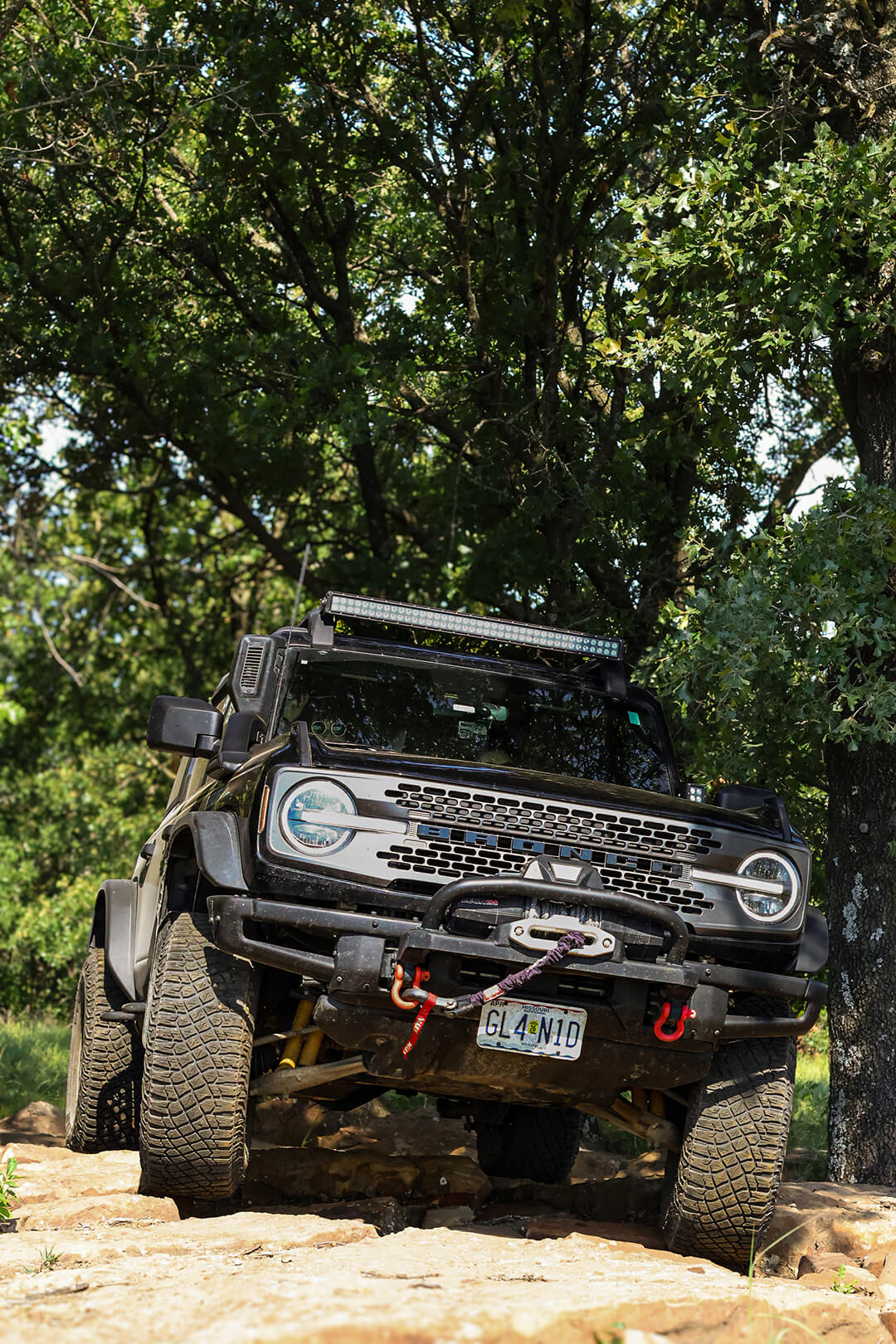 A front view of a black Ford Bronco with a roof light bar