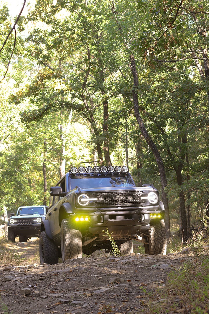 A front view of a black Ford Bronco with a roof light bar.